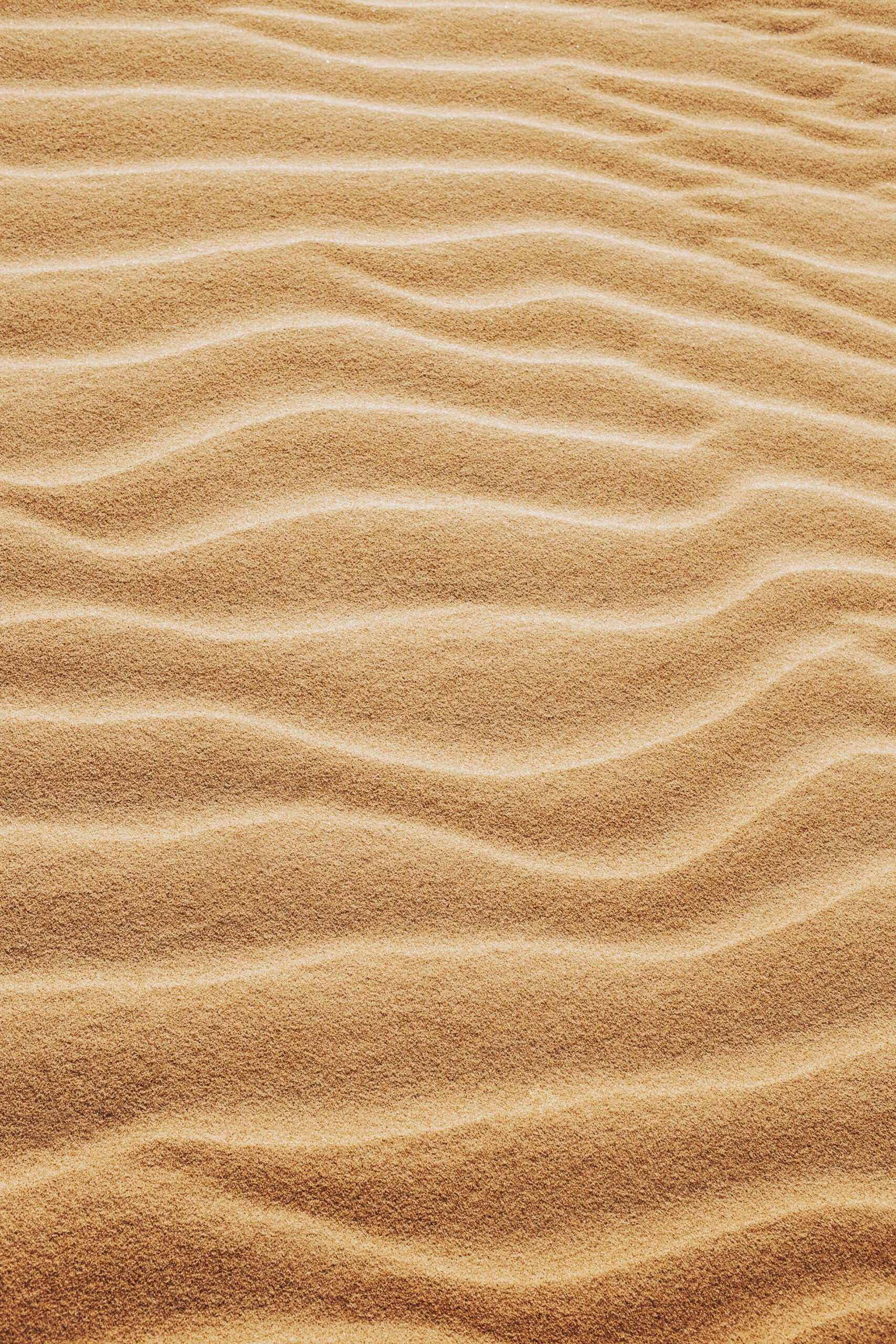 A vertical shot of the patterns on the sands in the desert